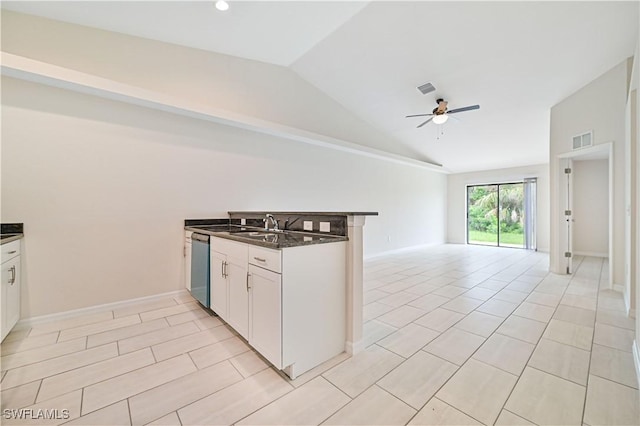 kitchen featuring vaulted ceiling, white cabinetry, dishwasher, ceiling fan, and kitchen peninsula