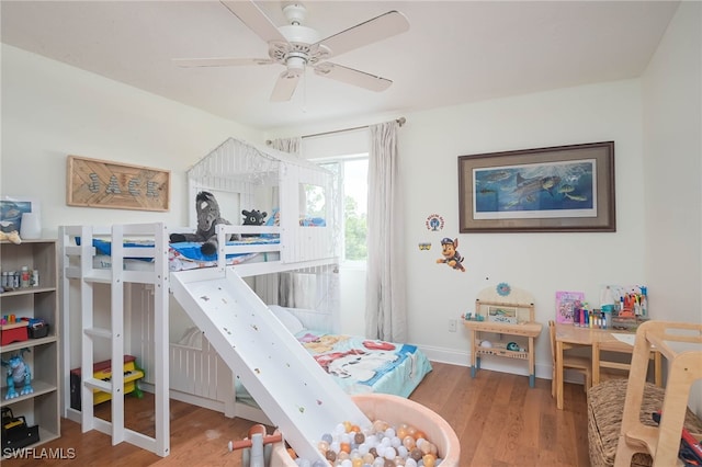 bedroom featuring ceiling fan, access to outside, and wood-type flooring