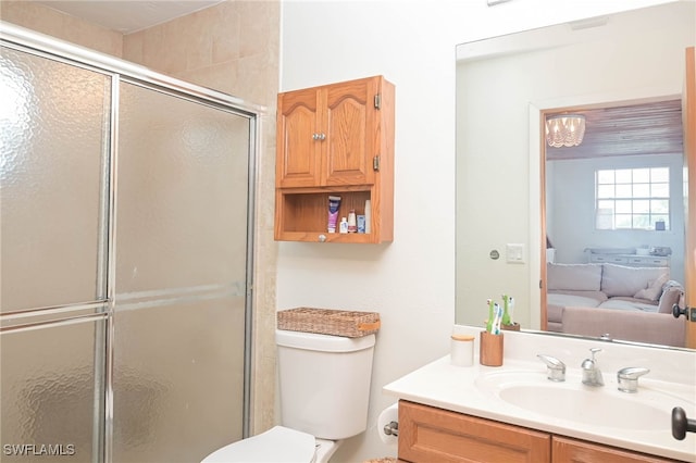 bathroom featuring toilet, vanity, and walk in shower