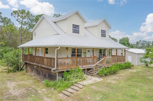 farmhouse-style home with covered porch and a front yard