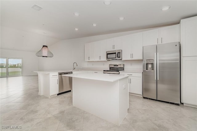 kitchen featuring stainless steel appliances, a kitchen island, a sink, white cabinets, and light countertops