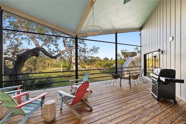 sunroom featuring lofted ceiling