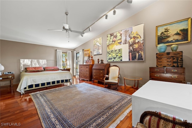 bedroom featuring hardwood / wood-style floors, track lighting, vaulted ceiling, and ceiling fan