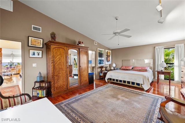 bedroom featuring dark hardwood / wood-style flooring, ceiling fan, and vaulted ceiling