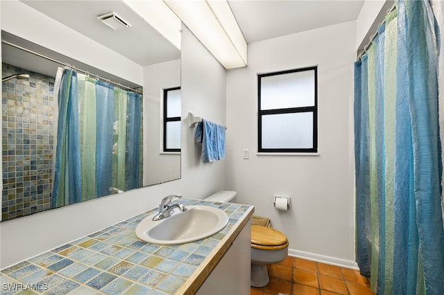 bathroom featuring toilet, vanity, tile patterned flooring, and a shower with curtain