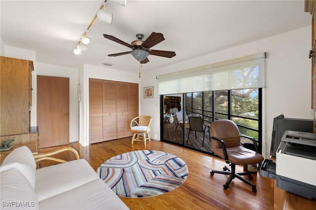 office featuring track lighting, ceiling fan, and light hardwood / wood-style floors