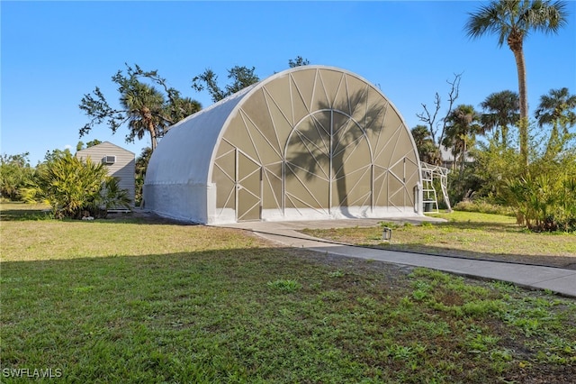 view of outbuilding with a lawn