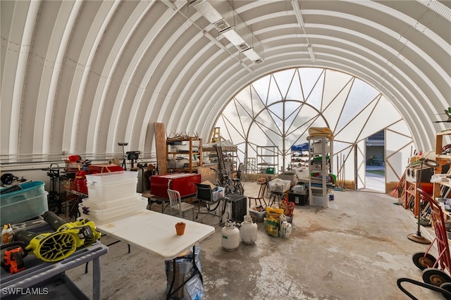 misc room featuring lofted ceiling and concrete floors