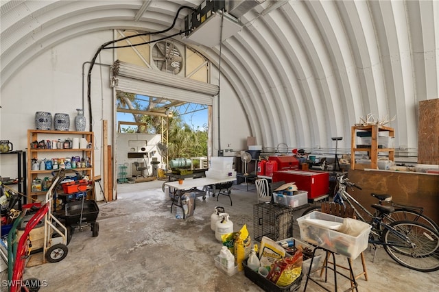 misc room with lofted ceiling and concrete flooring