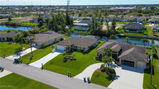 drone / aerial view with a residential view and a water view