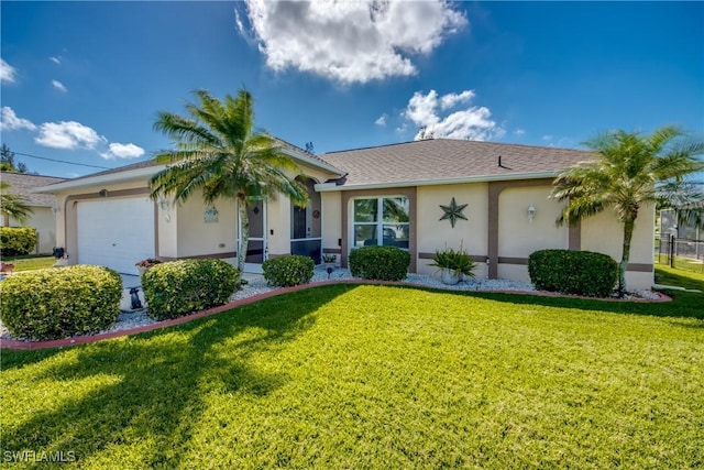 ranch-style home with a garage, a front yard, and stucco siding