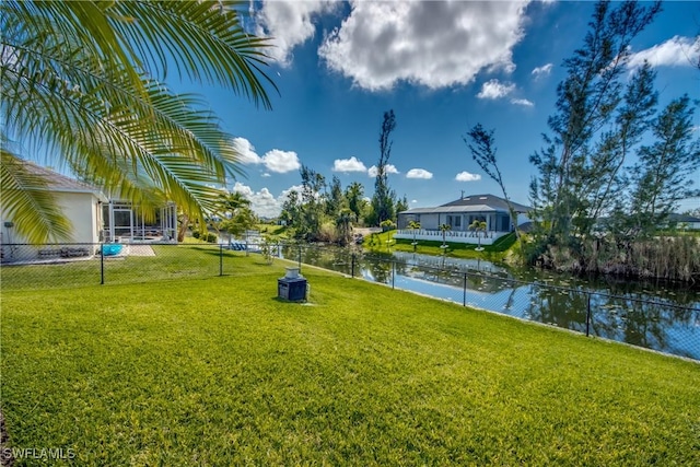 view of yard with a water view and fence