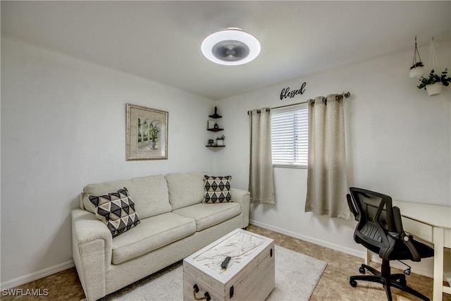 living area featuring baseboards