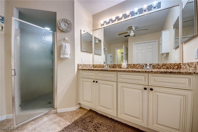 bathroom featuring a sink, a stall shower, tile patterned flooring, and a ceiling fan