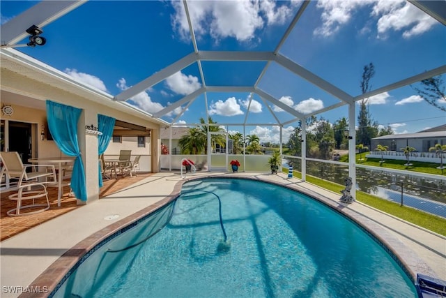 pool with a patio area and glass enclosure