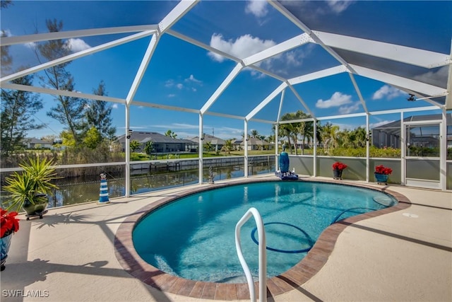 pool with a lanai, a water view, and a patio