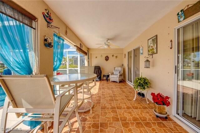 sunroom featuring ceiling fan