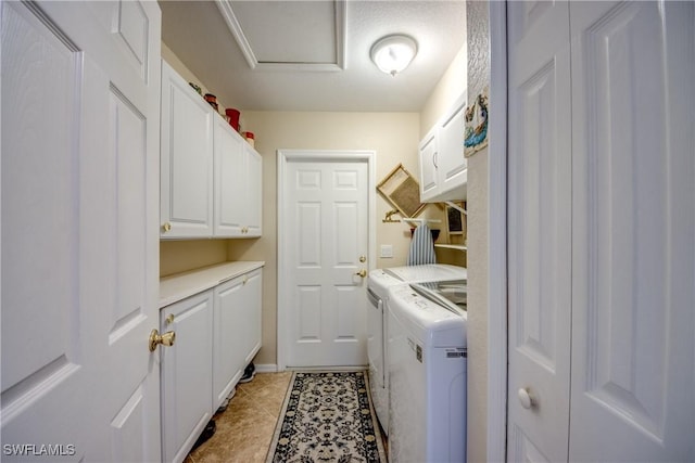 laundry room featuring cabinet space, attic access, light tile patterned floors, and independent washer and dryer