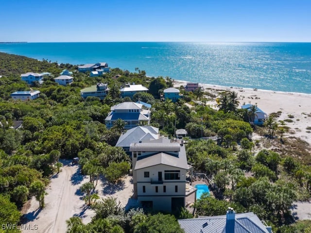 aerial view with a water view and a beach view