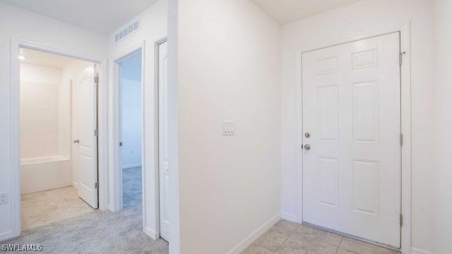 hall with light tile patterned flooring