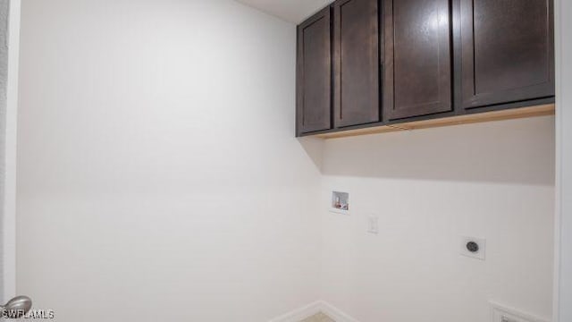 washroom with washer hookup, cabinets, and hookup for an electric dryer