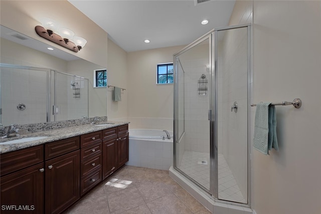 full bathroom with double vanity, a sink, a shower stall, a bath, and tile patterned floors