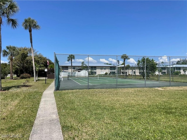 view of tennis court with a lawn