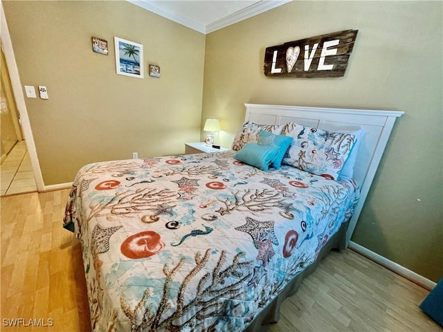 bedroom with hardwood / wood-style flooring and crown molding