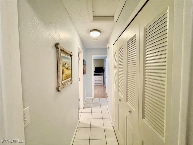 hall with light tile patterned floors