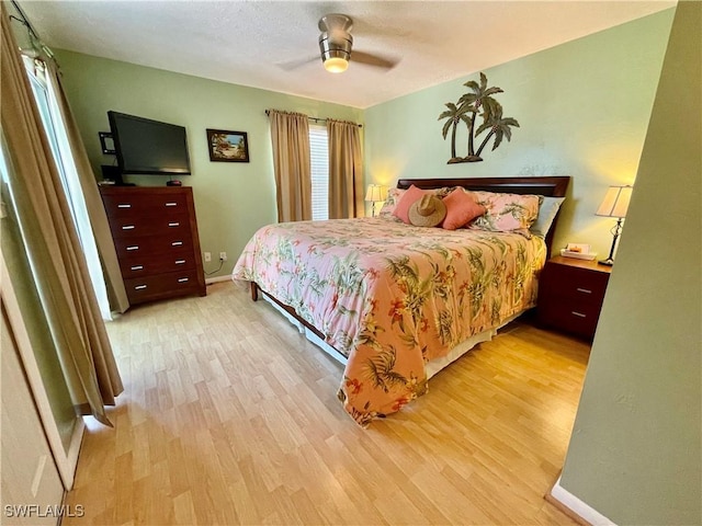 bedroom with light hardwood / wood-style flooring and ceiling fan