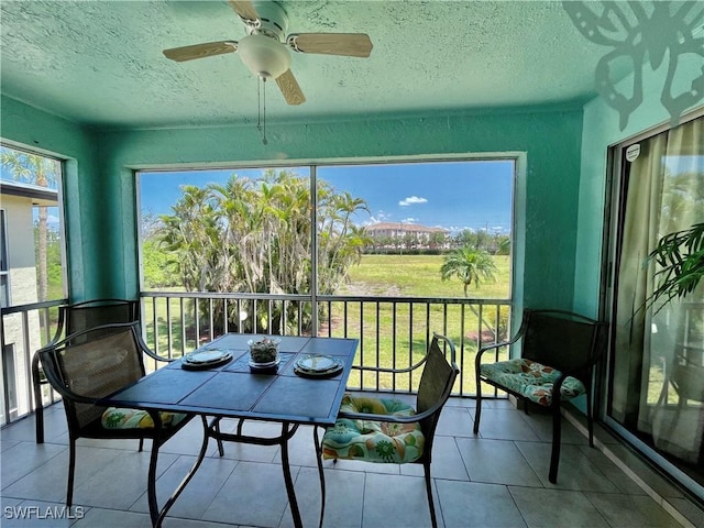 sunroom / solarium featuring ceiling fan