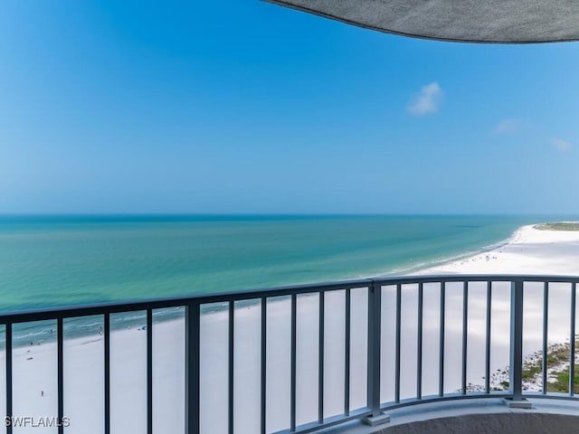 balcony with a water view and a beach view