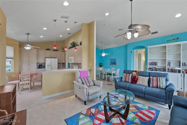 tiled living room featuring ceiling fan and a high ceiling