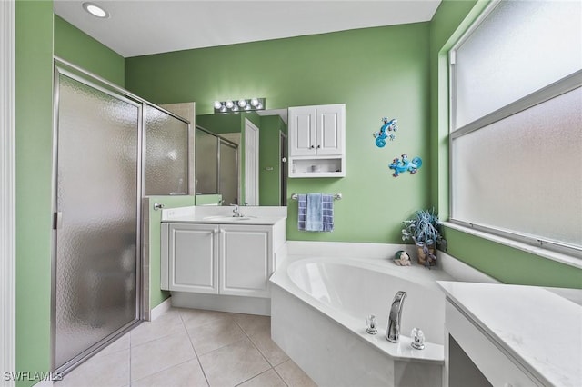 bathroom with tile patterned floors, vanity, and independent shower and bath