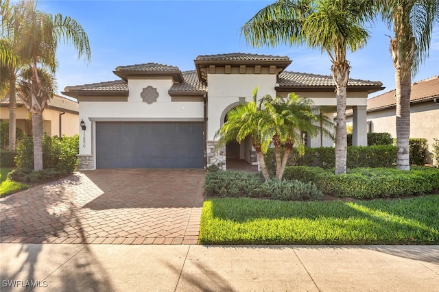 mediterranean / spanish home featuring a garage