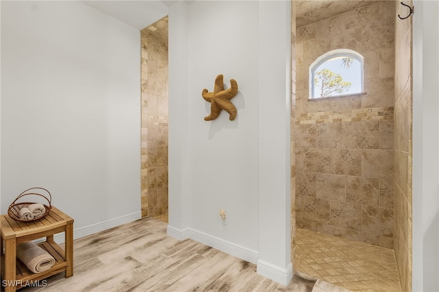 15791 Quail Trl, Bokeelia, FL 33922 - bathroom featuring a walk in shower, wood finished floors, and baseboards