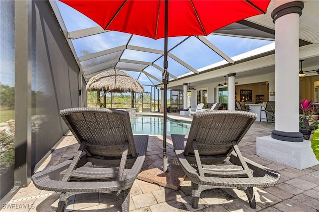 15791 Quail Trl, Bokeelia, FL 33922 - pool featuring a patio area, ceiling fan, glass enclosure, and outdoor dry bar