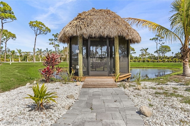 15791 Quail Trl, Bokeelia, FL 33922 - entrance to property featuring a water view, a lawn, and stucco siding