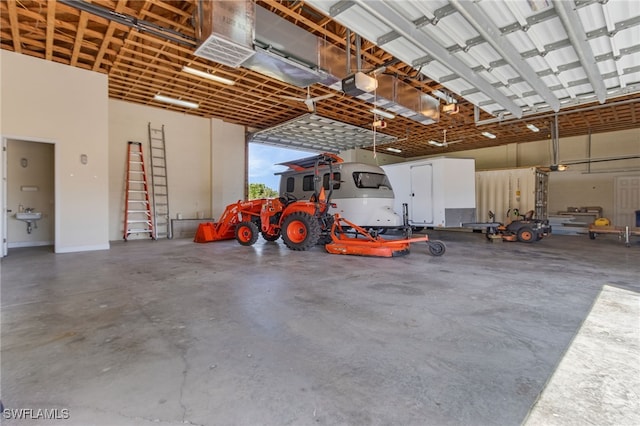 15791 Quail Trl, Bokeelia, FL 33922 - garage featuring a sink and a garage door opener