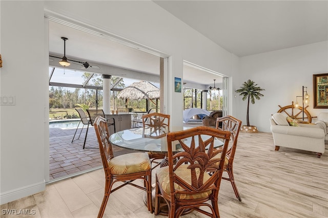 15791 Quail Trl, Bokeelia, FL 33922 - dining area with a sunroom, a healthy amount of sunlight, and light wood finished floors