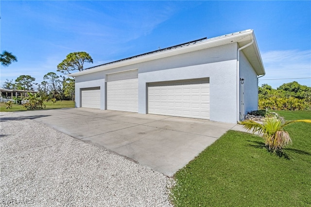 garage with concrete driveway