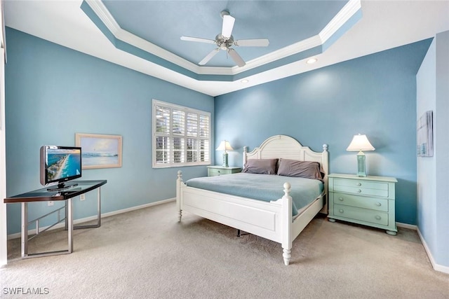 bedroom featuring a raised ceiling, ornamental molding, a ceiling fan, carpet flooring, and baseboards