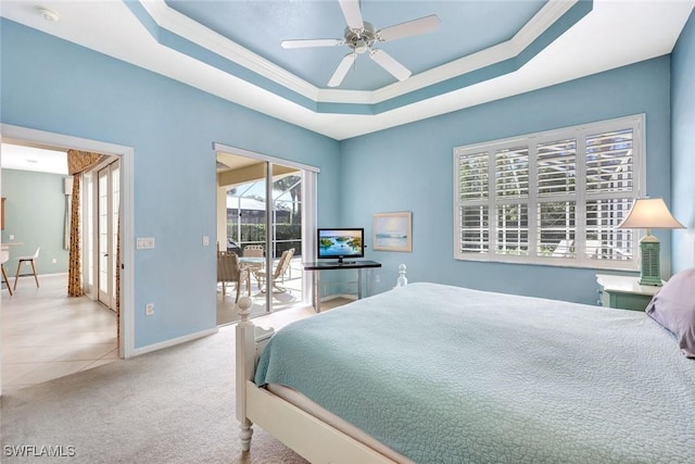 carpeted bedroom with baseboards, a tray ceiling, a ceiling fan, and access to exterior