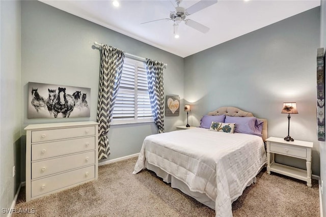 carpeted bedroom with a ceiling fan and baseboards