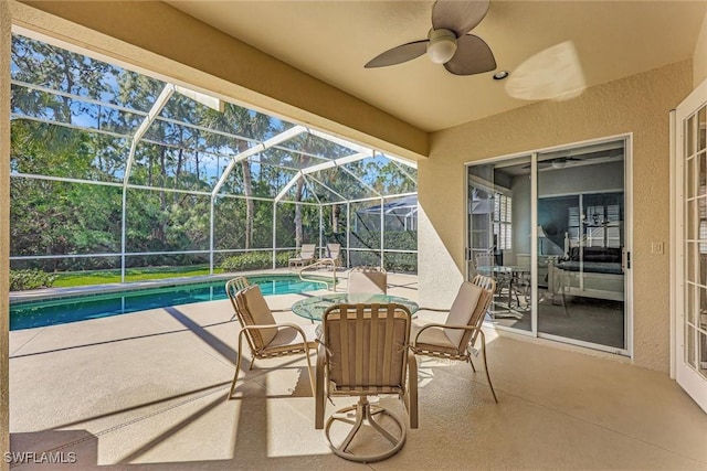 view of patio / terrace with a lanai, ceiling fan, and an outdoor pool