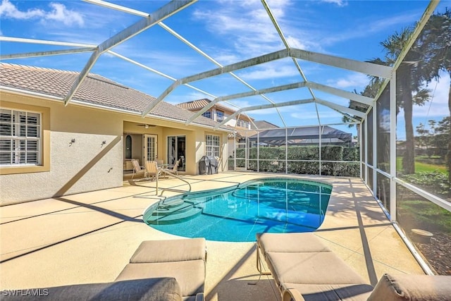 pool with a lanai and a patio area