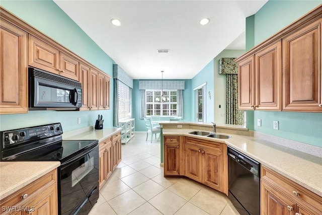 kitchen featuring light tile patterned floors, a sink, light countertops, brown cabinets, and black appliances