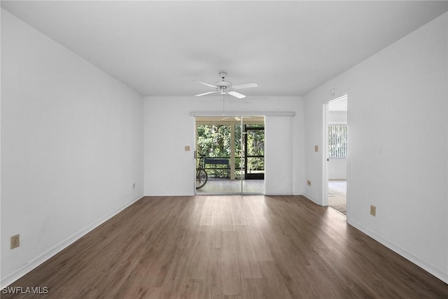 unfurnished room with ceiling fan and dark hardwood / wood-style flooring