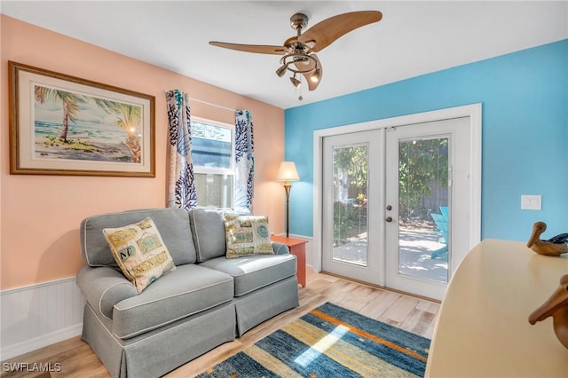 living room featuring french doors, ceiling fan, and light hardwood / wood-style flooring