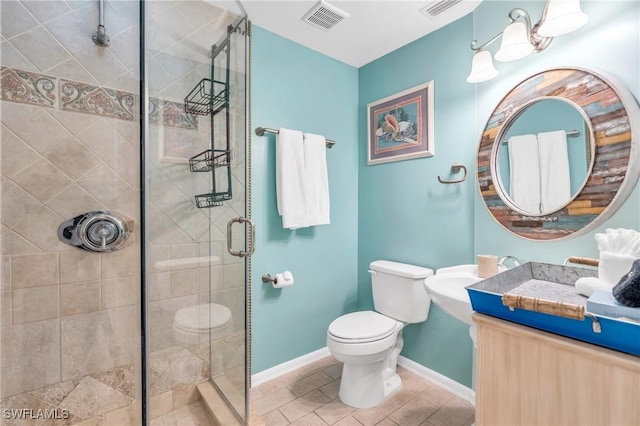 bathroom with vanity, toilet, and a shower with door